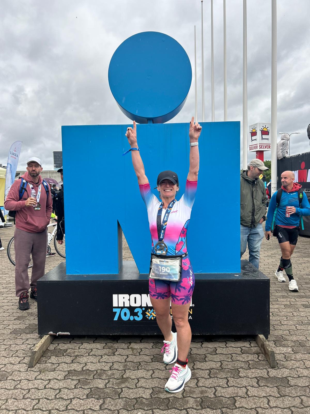 Alison celebrating after completing an IRONMAN 70.3 race